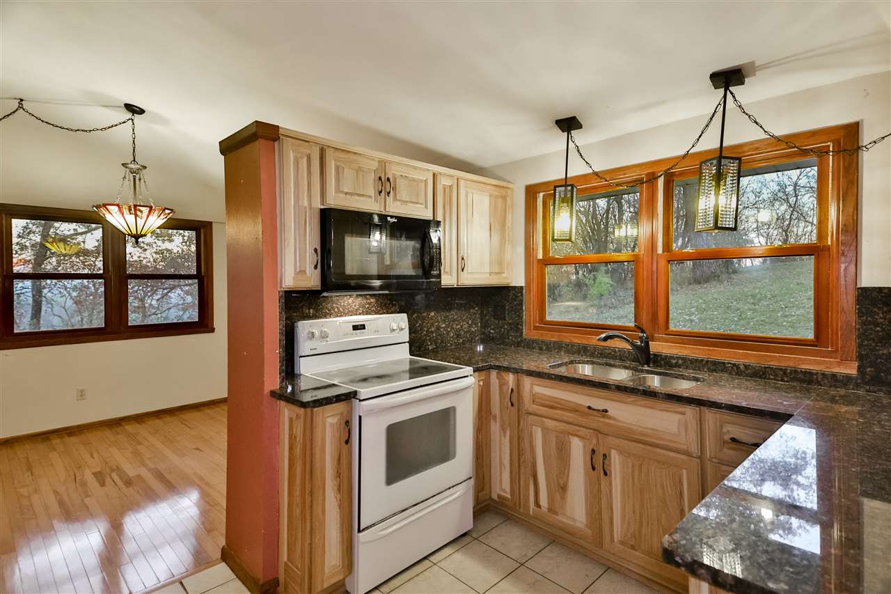 118 North Elizabeth Scales Mound Road Elizabeth, IL 61028 - Photo 19 of 40 a kitchen with a sink stove and microwave