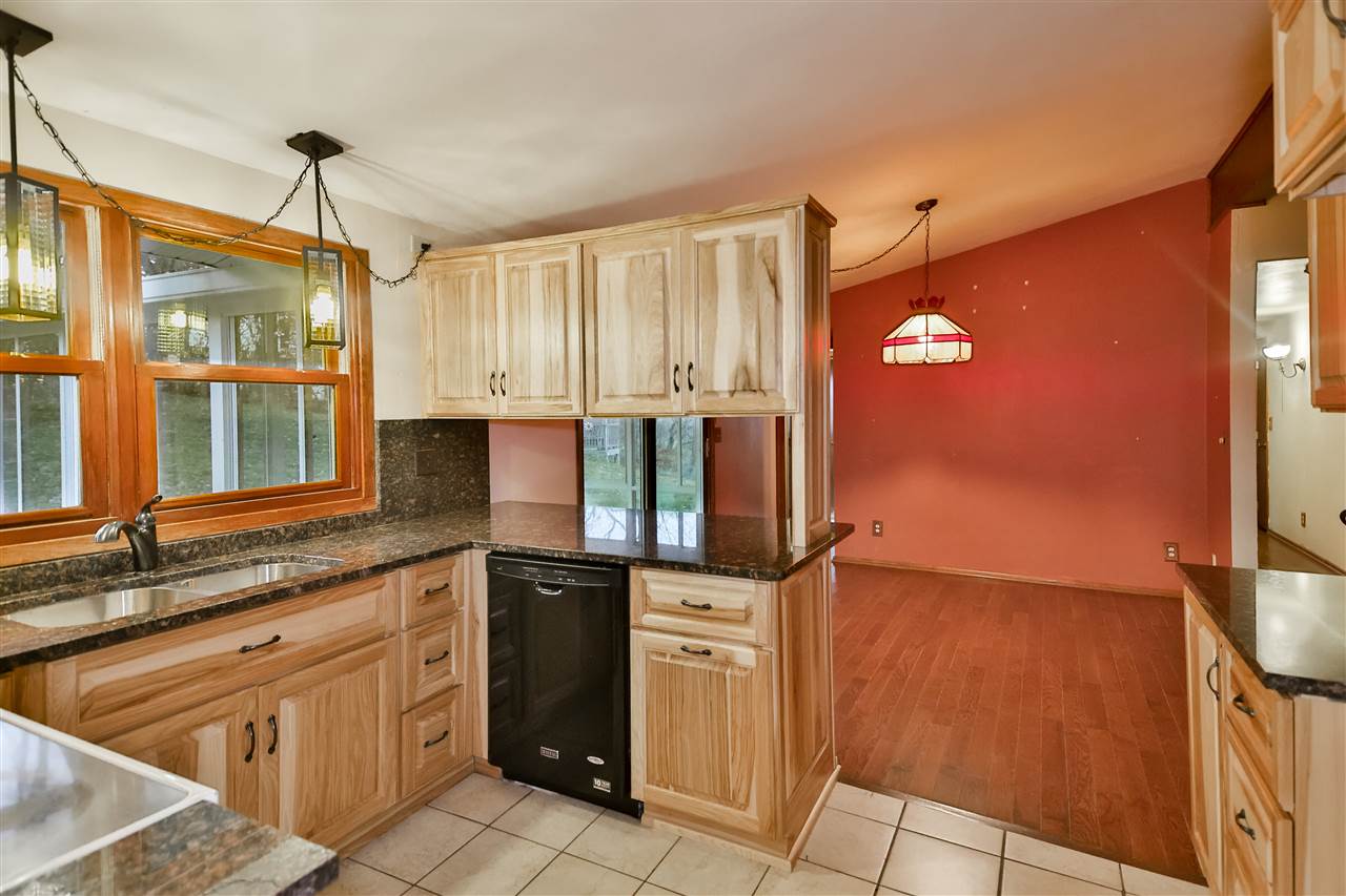 118 North Elizabeth Scales Mound Road Elizabeth, IL 61028 - Photo 20 of 40 a kitchen with stainless steel appliances granite countertop a sink and a refrigerator