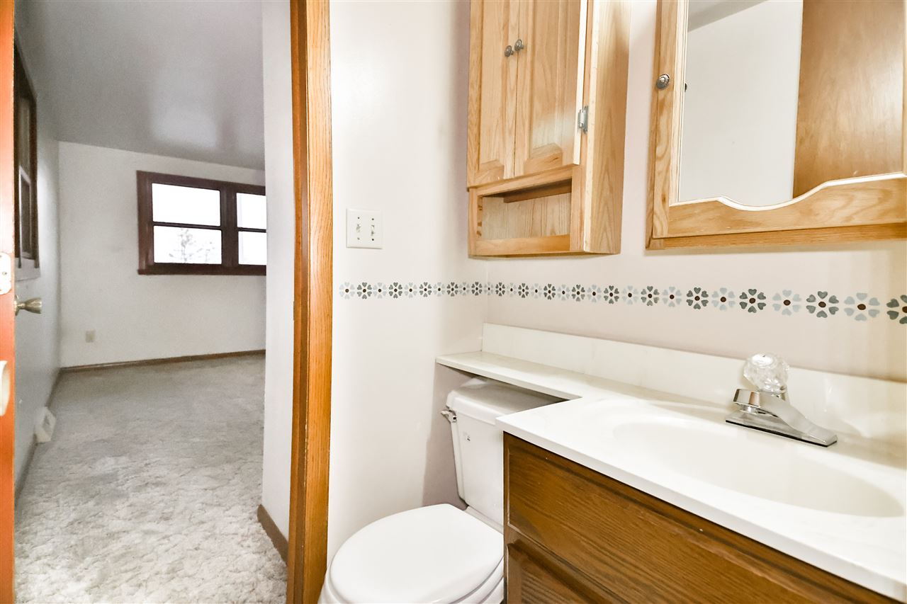 118 North Elizabeth Scales Mound Road Elizabeth, IL 61028 - Photo 27 of 40 a bathroom with a sink and a mirror