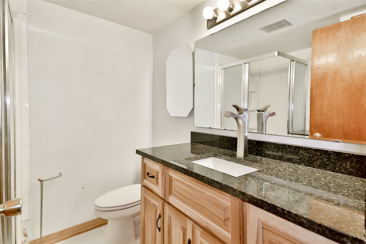 118 North Elizabeth Scales Mound Road Elizabeth, IL 61028 - Photo 28 of 40 a bathroom with a granite countertop sink a toilet and a mirror