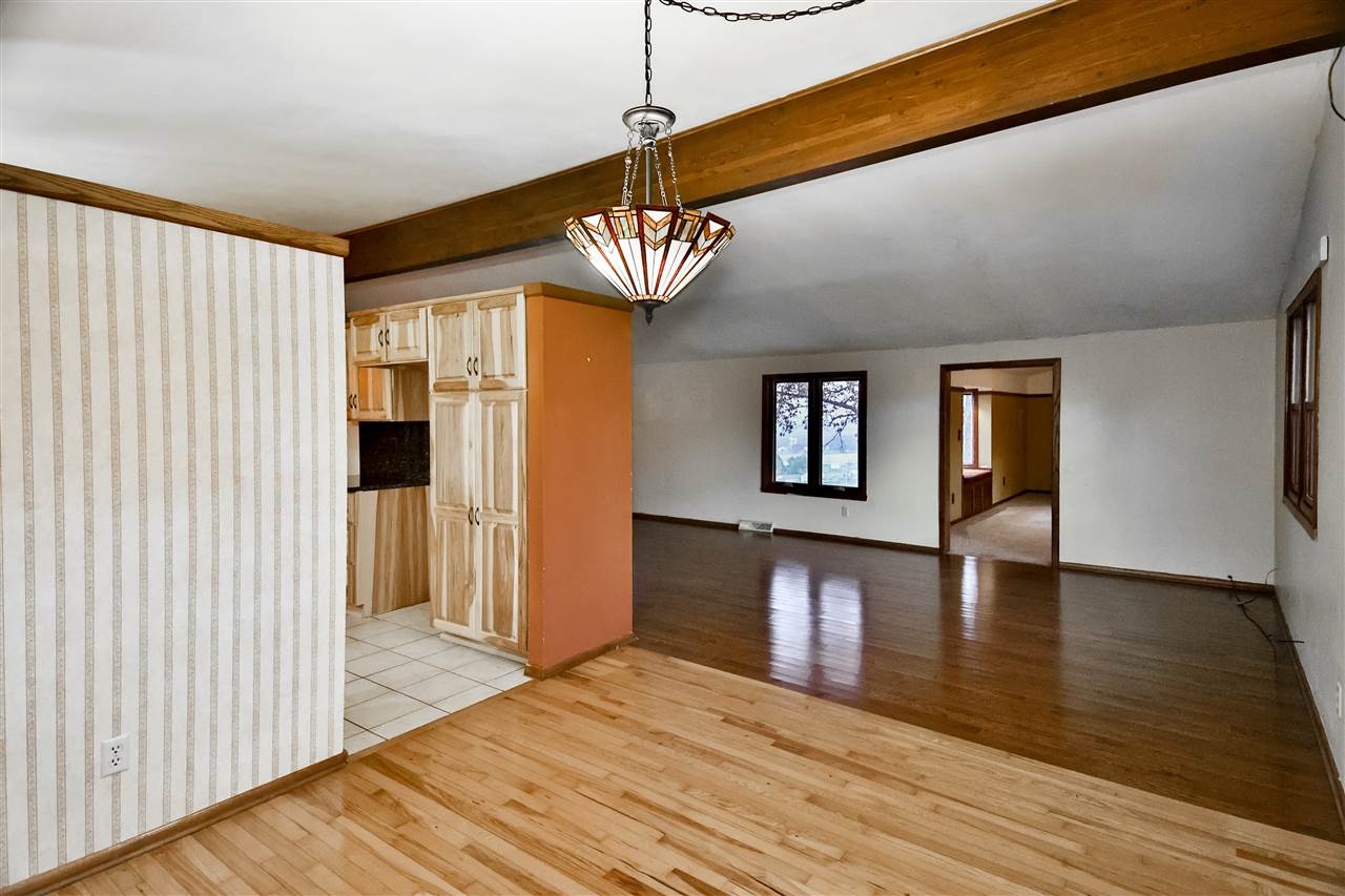 118 North Elizabeth Scales Mound Road Elizabeth, IL 61028 - Photo 9 of 40 a view of a livingroom with wooden floor and a ceiling fan
