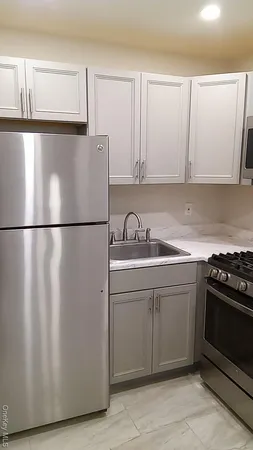 a kitchen with cabinets and a stove top oven