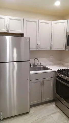 a kitchen with cabinets and a stove top oven