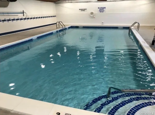 a room with pool table and windows