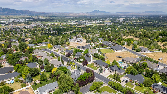 288 525 South Providence, UT 84332 - Photo 70 of 71 Residential streetscape featuring single-family homes, mature trees, and a paved road network