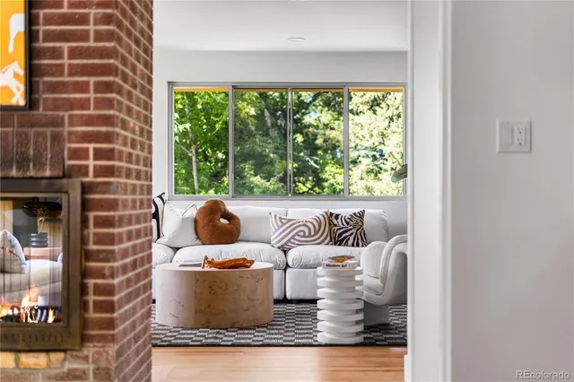 a view of a living room with a floor to ceiling window and floor