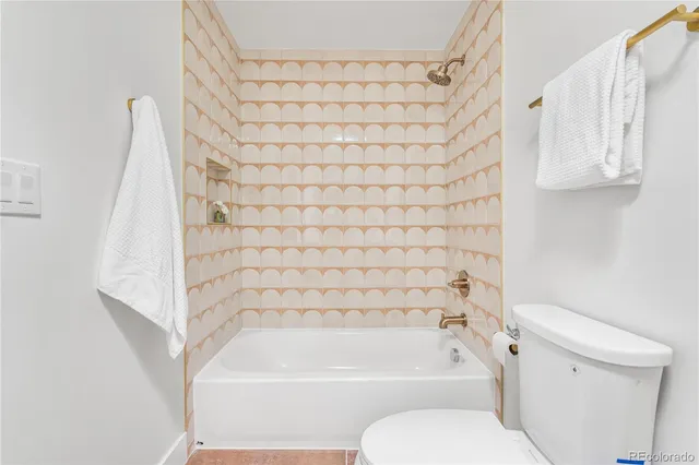 a bathroom with a bathtub and a toilet