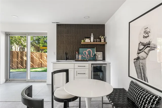 a kitchen with a table chairs and a refrigerator