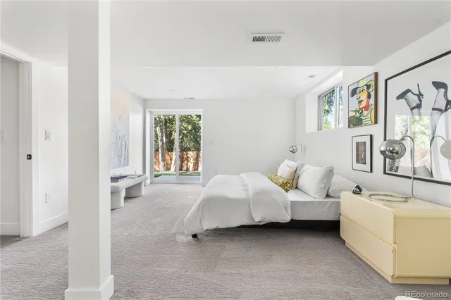 a bed room with furniture and window