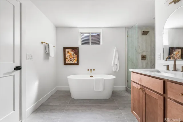 a spacious bathroom with a sink and a mirror