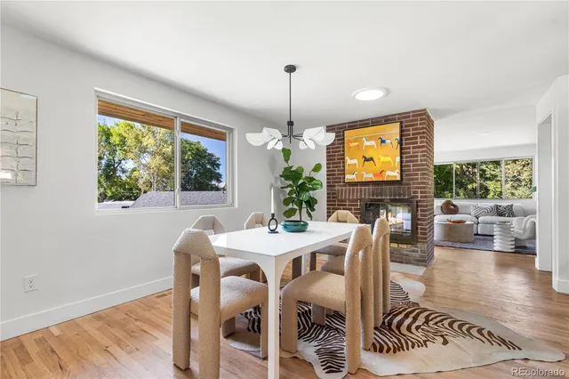 a dining room with furniture window and wooden floor