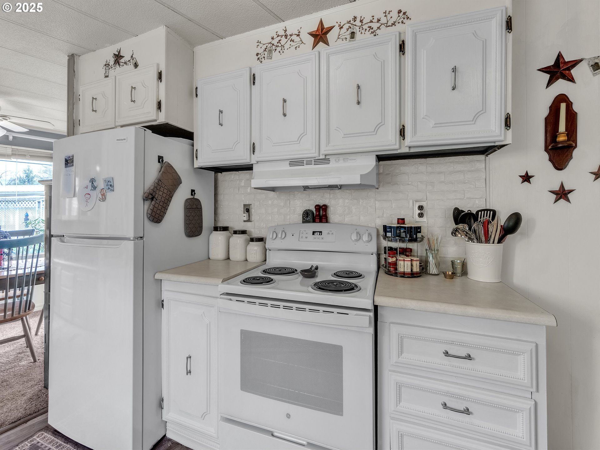 2902 East 2nd Street, Unit 98 Newberg, OR 97132 - Photo 11 of 25 a kitchen with white cabinets and white appliances