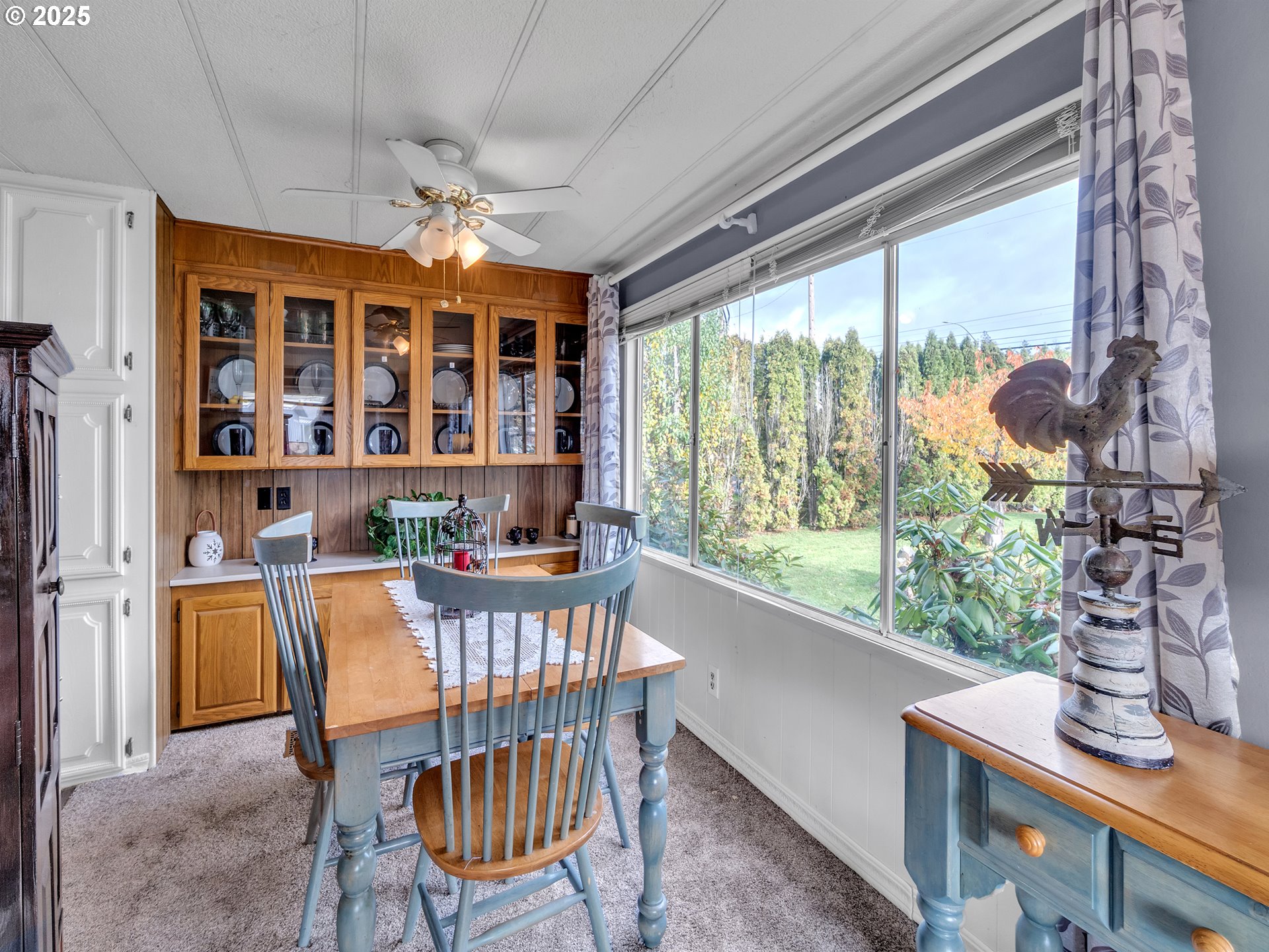 2902 East 2nd Street, Unit 98 Newberg, OR 97132 - Photo 12 of 25 a dining room with furniture a chandelier and wooden floor