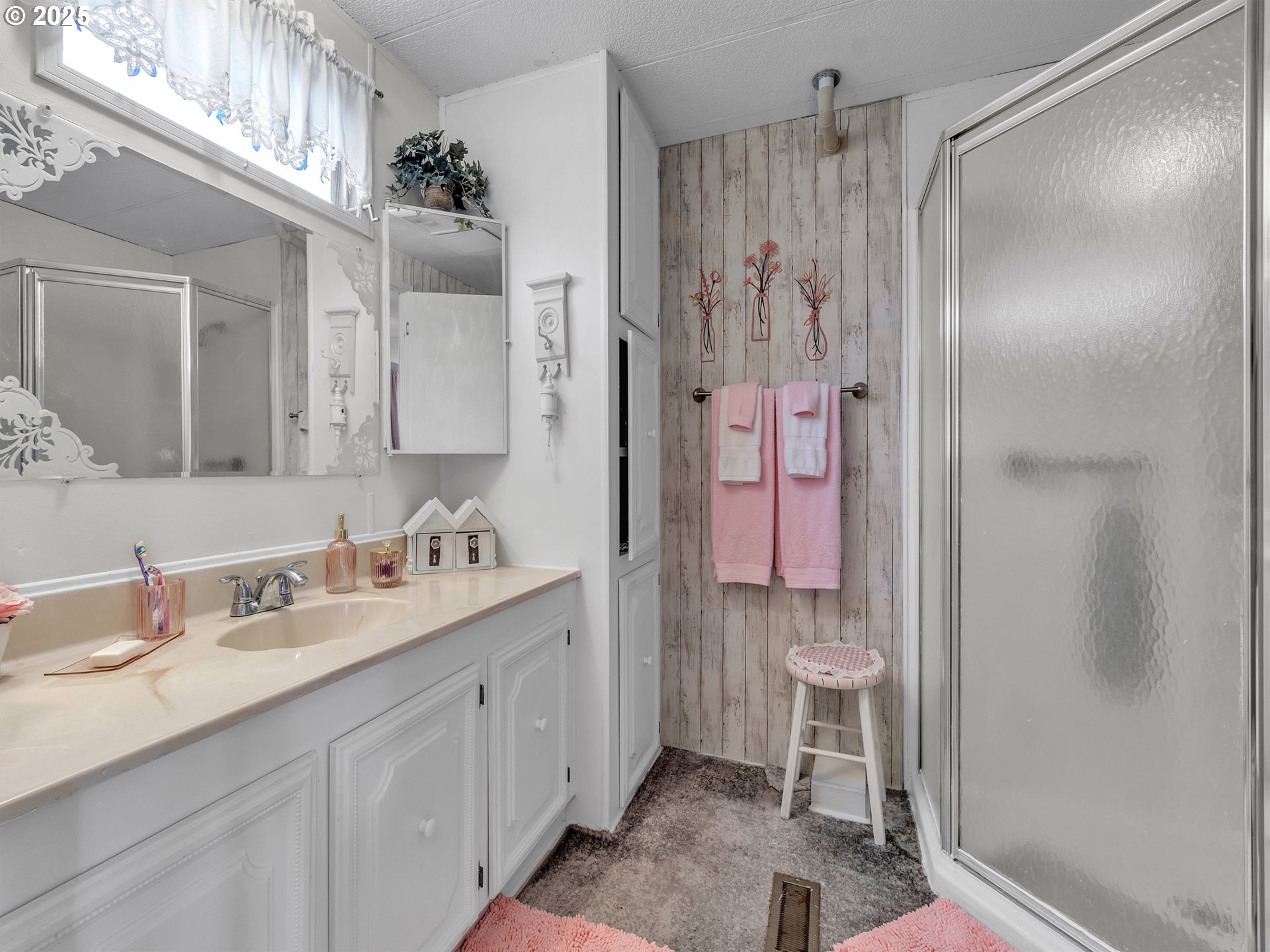2902 East 2nd Street, Unit 98 Newberg, OR 97132 - Photo 17 of 25 a spacious bathroom with a shower sink and mirror