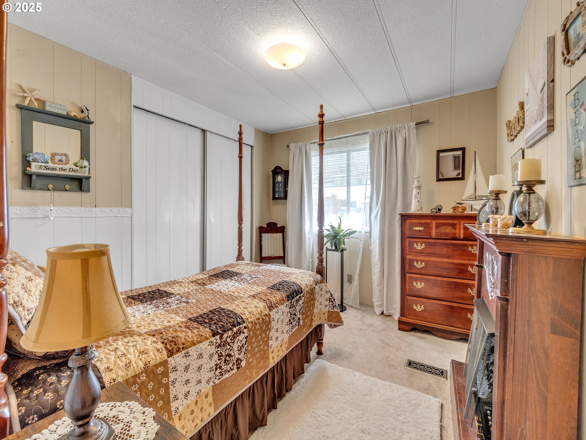 2902 East 2nd Street, Unit 98 Newberg, OR 97132 - Photo 18 of 25 a bedroom with a bed and furniture