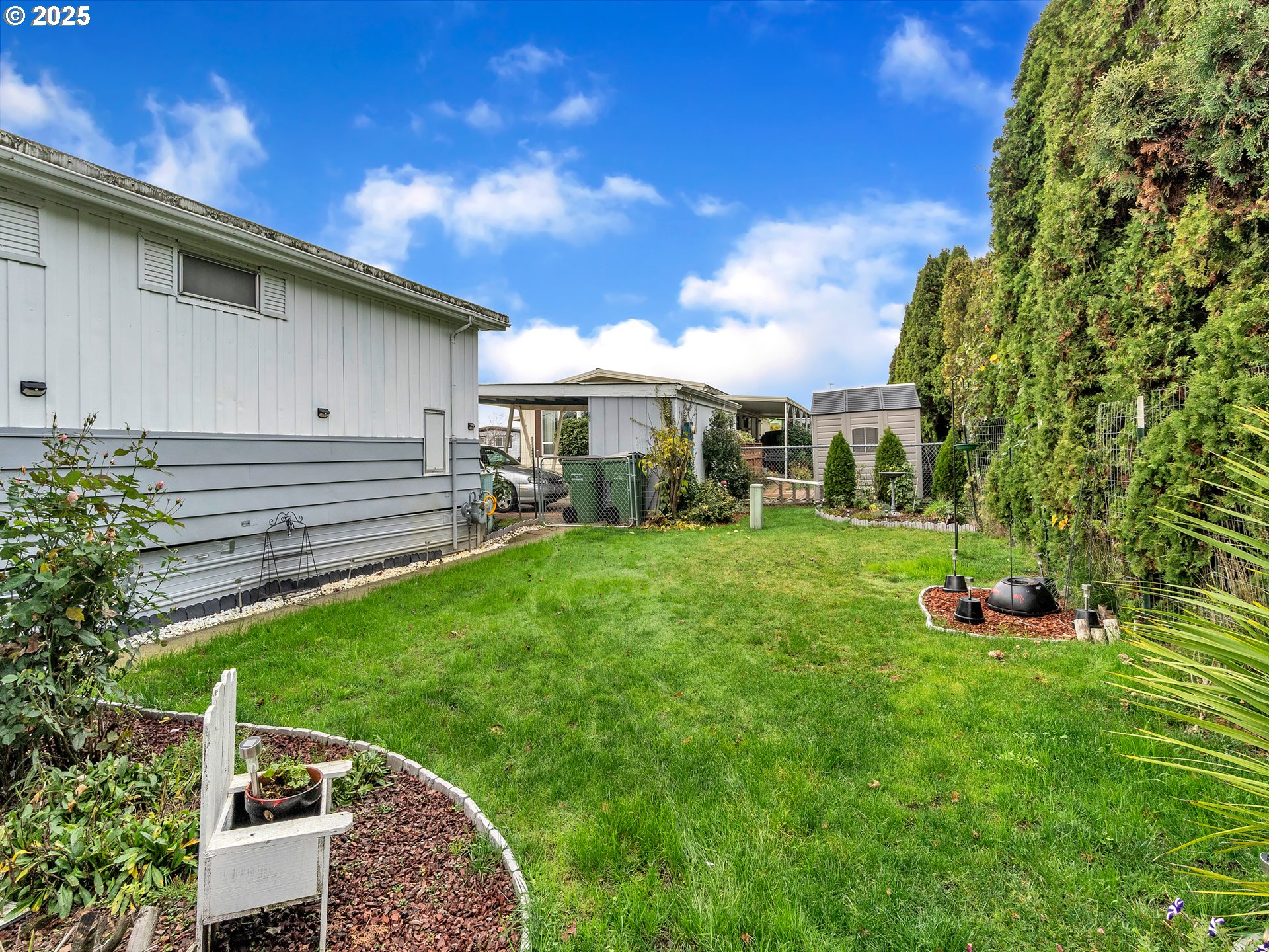 2902 East 2nd Street, Unit 98 Newberg, OR 97132 - Photo 23 of 25 a front view of a house with garden