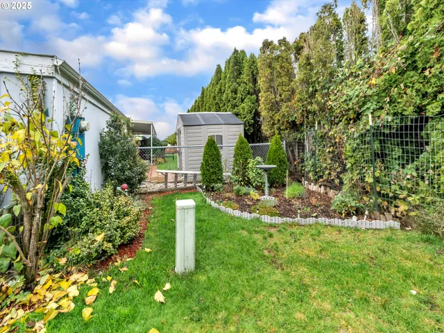 a view of a chair and table in the garden