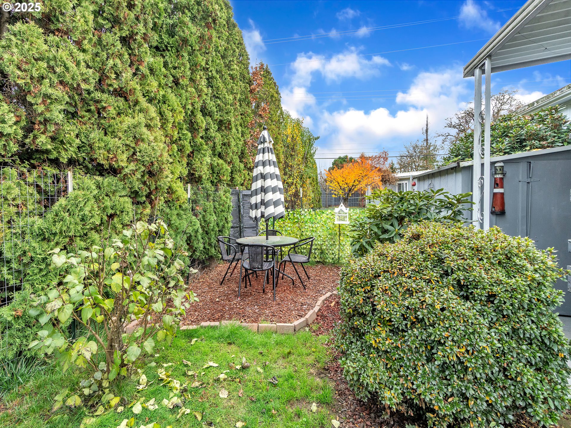 2902 East 2nd Street, Unit 98 Newberg, OR 97132 - Photo 25 of 25 a view of a chair and table in the garden