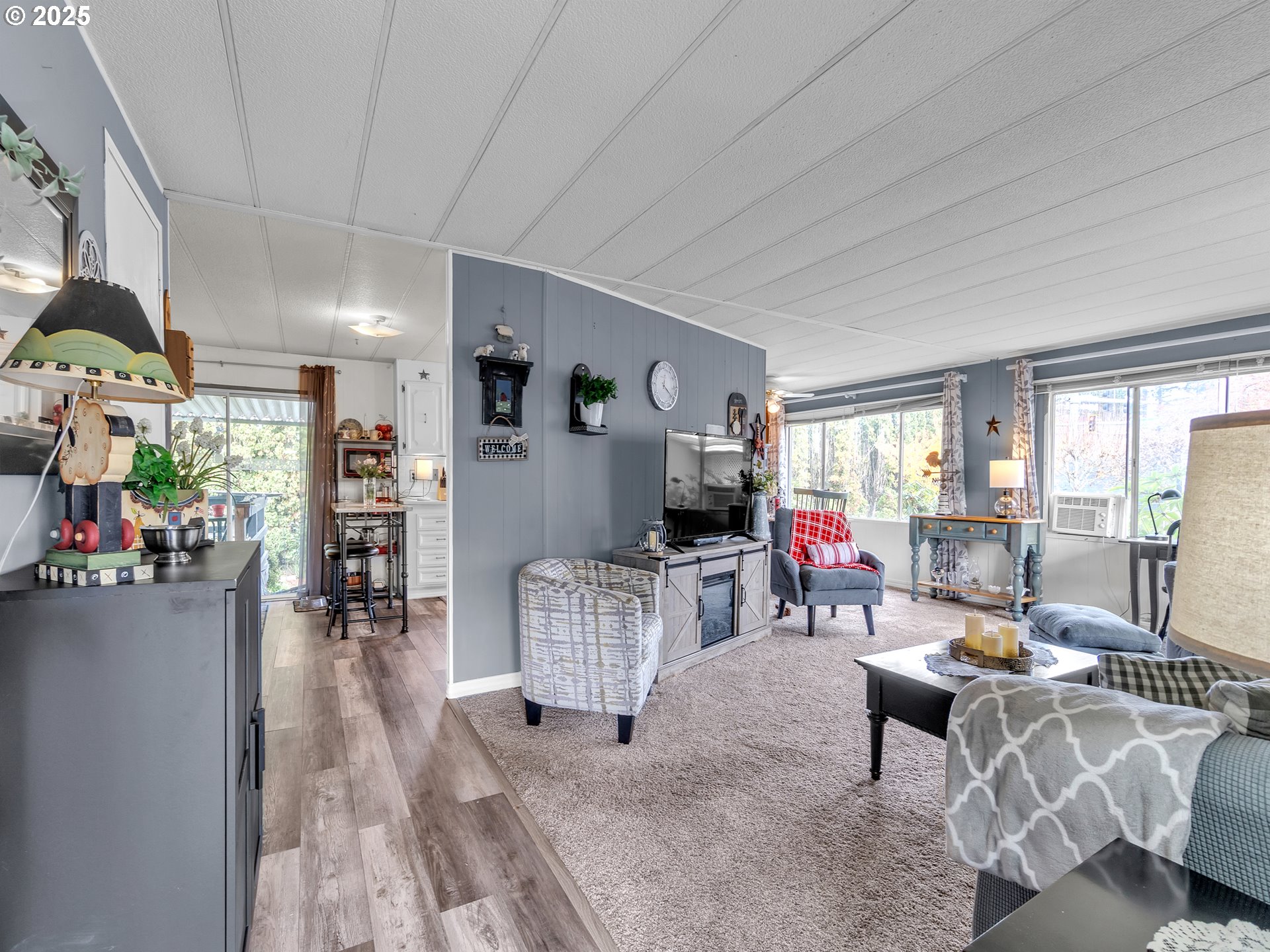 2902 East 2nd Street, Unit 98 Newberg, OR 97132 - Photo 6 of 25 a living room with furniture and a flat screen tv