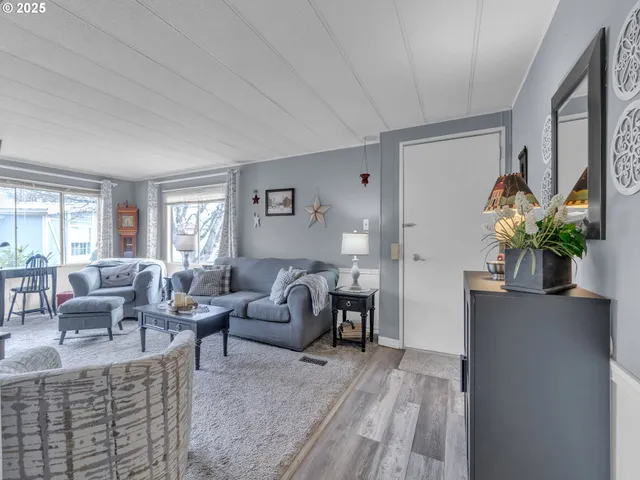 a living room with furniture potted plant and a window