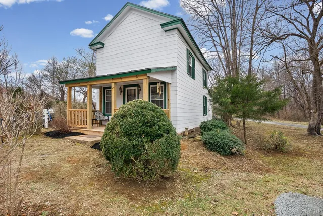 a backyard of a house with large trees and outdoor space