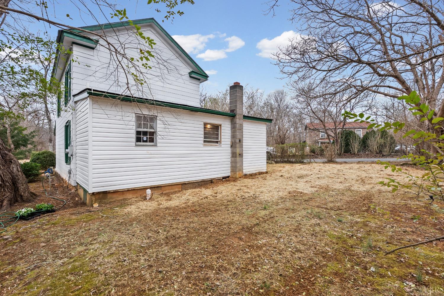 26 Braddock Lane Shipman, VA 22971 - Photo 26 of 37 a backyard of a house with large trees and barbeque oven