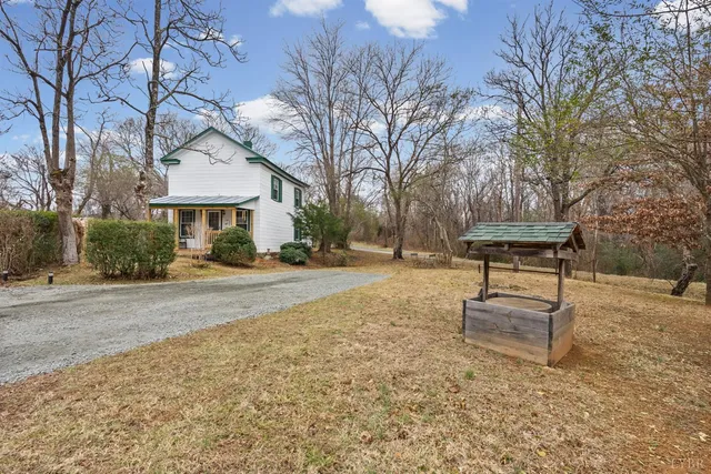 a view of a house with a yard covered in snow