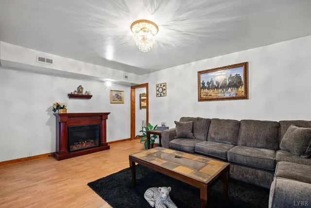a living room with furniture a fireplace and a large mirror