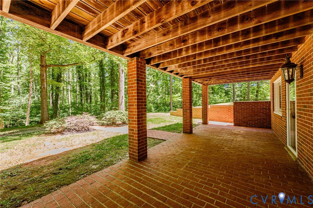 15611 Robert Terrell Road Montpelier, VA 23192 - Photo 24 of 28 Covered brick patio featuring wood ceiling joists