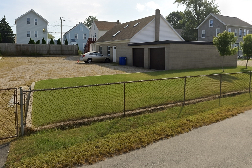 a front view of a house with plants