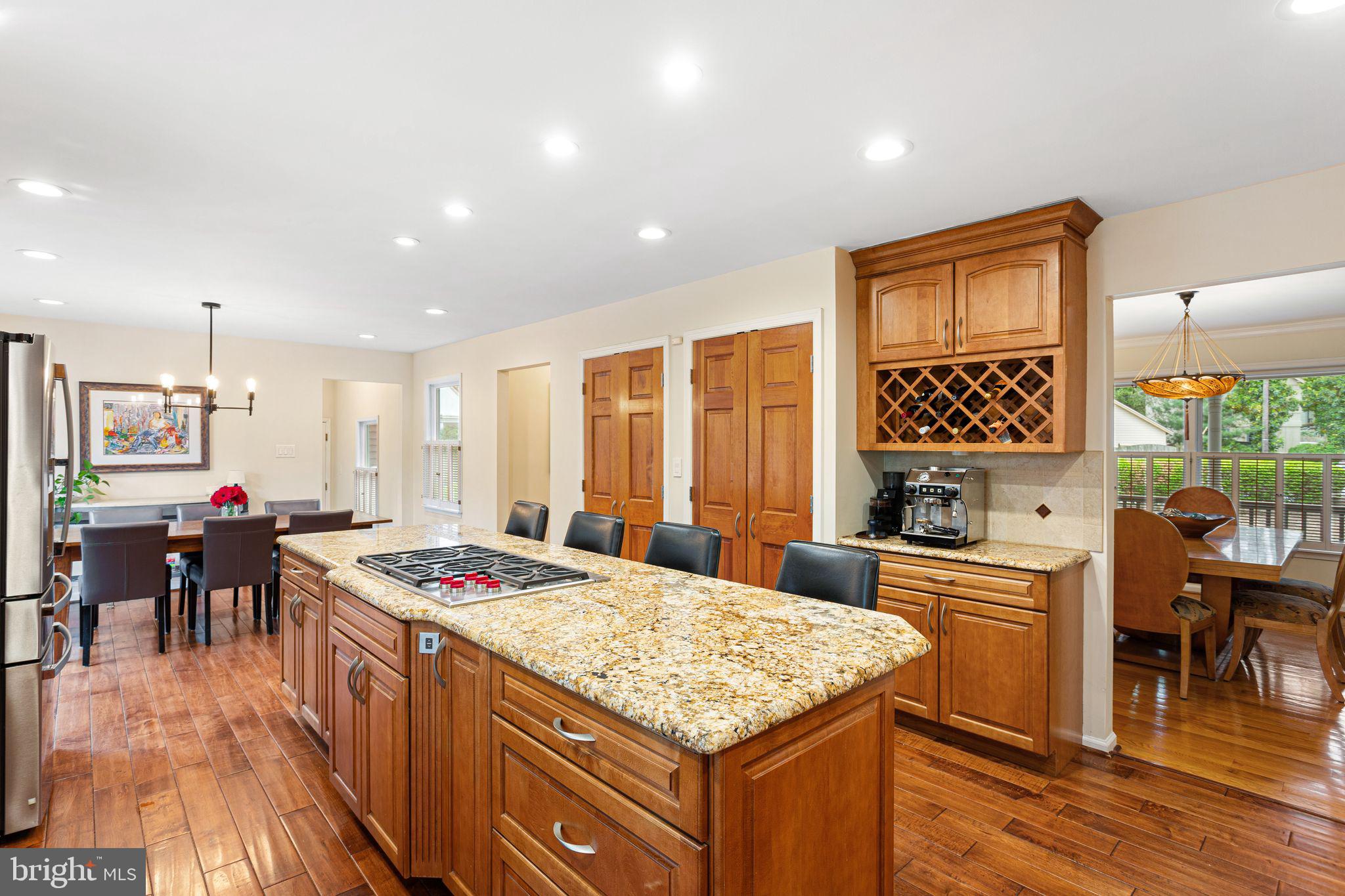 51 Chestnut Street Haddonfield, NJ 08033 - Photo 18 of 56 a kitchen with stainless steel appliances granite countertop a stove top oven a sink a dining table and chairs with wooden floor