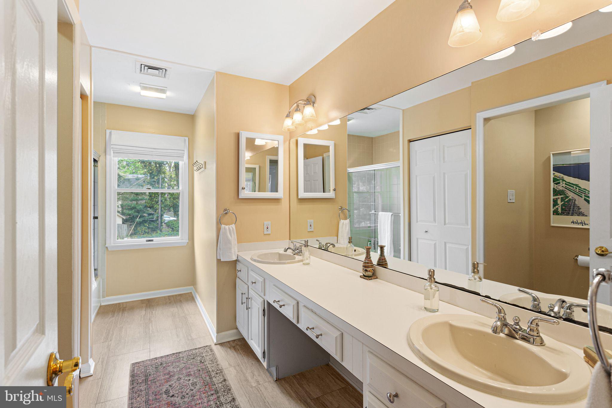51 Chestnut Street Haddonfield, NJ 08033 - Photo 34 of 56 a bathroom with a granite countertop double vanity sink a mirror and a bathtub