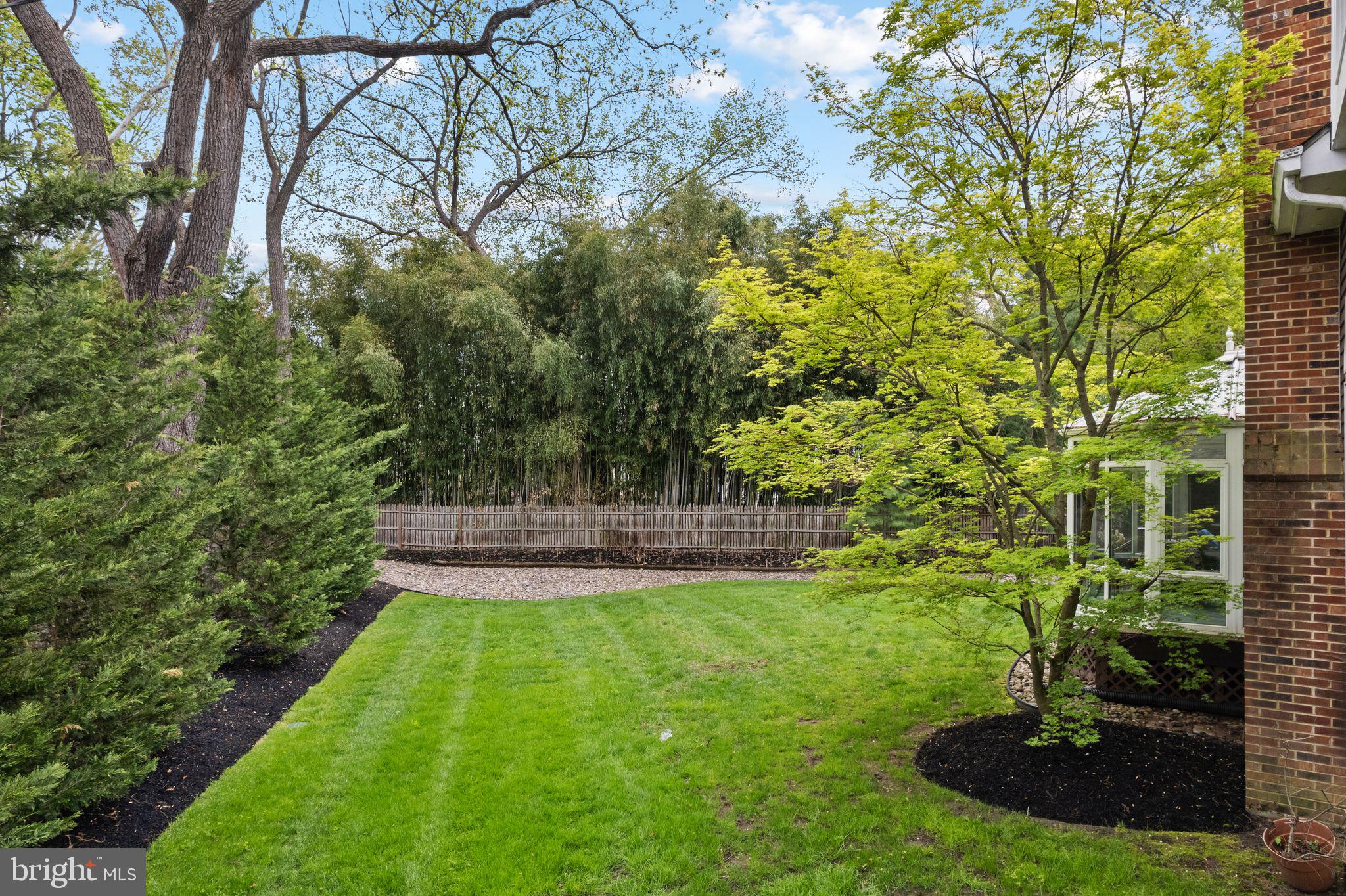 51 Chestnut Street Haddonfield, NJ 08033 - Photo 42 of 56 a view of a garden with a bench