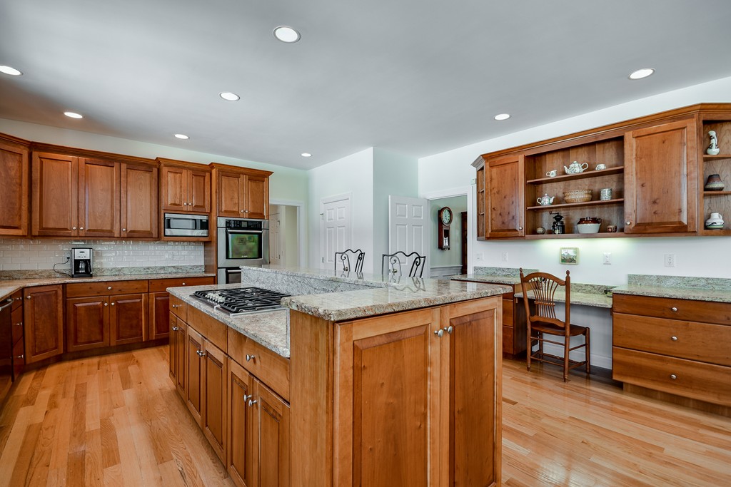 32 Fieldstone Farm Road Sudbury, MA 01776 - Photo 12 of 30 a kitchen with stainless steel appliances granite countertop a sink stove and cabinets