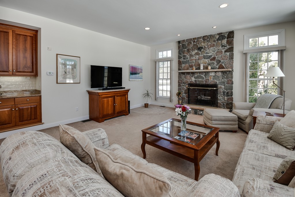32 Fieldstone Farm Road Sudbury, MA 01776 - Photo 9 of 30 a living room with furniture and a fireplace