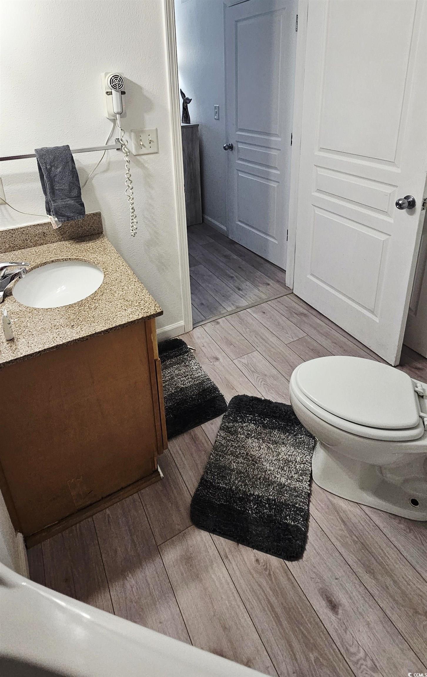 7100 North Ocean Boulevard, Unit 724 Myrtle Beach, SC 29572 - Photo 12 of 16 Bathroom with light wood finished floors and vanity