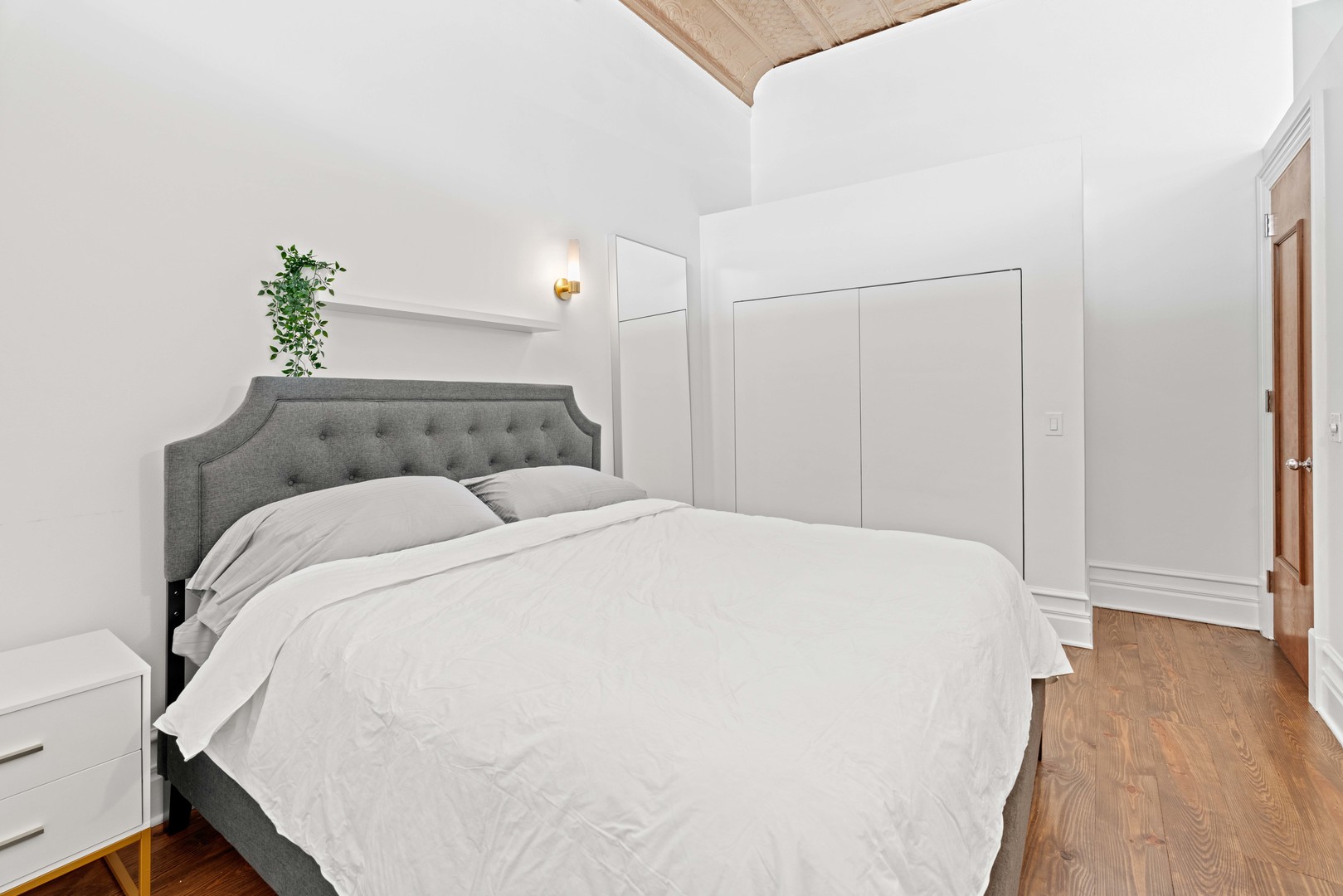 1400 West Chestnut Street, Unit 1 Chicago, IL 60642 - Photo 12 of 24 a bed sitting in a bedroom and wooden floor