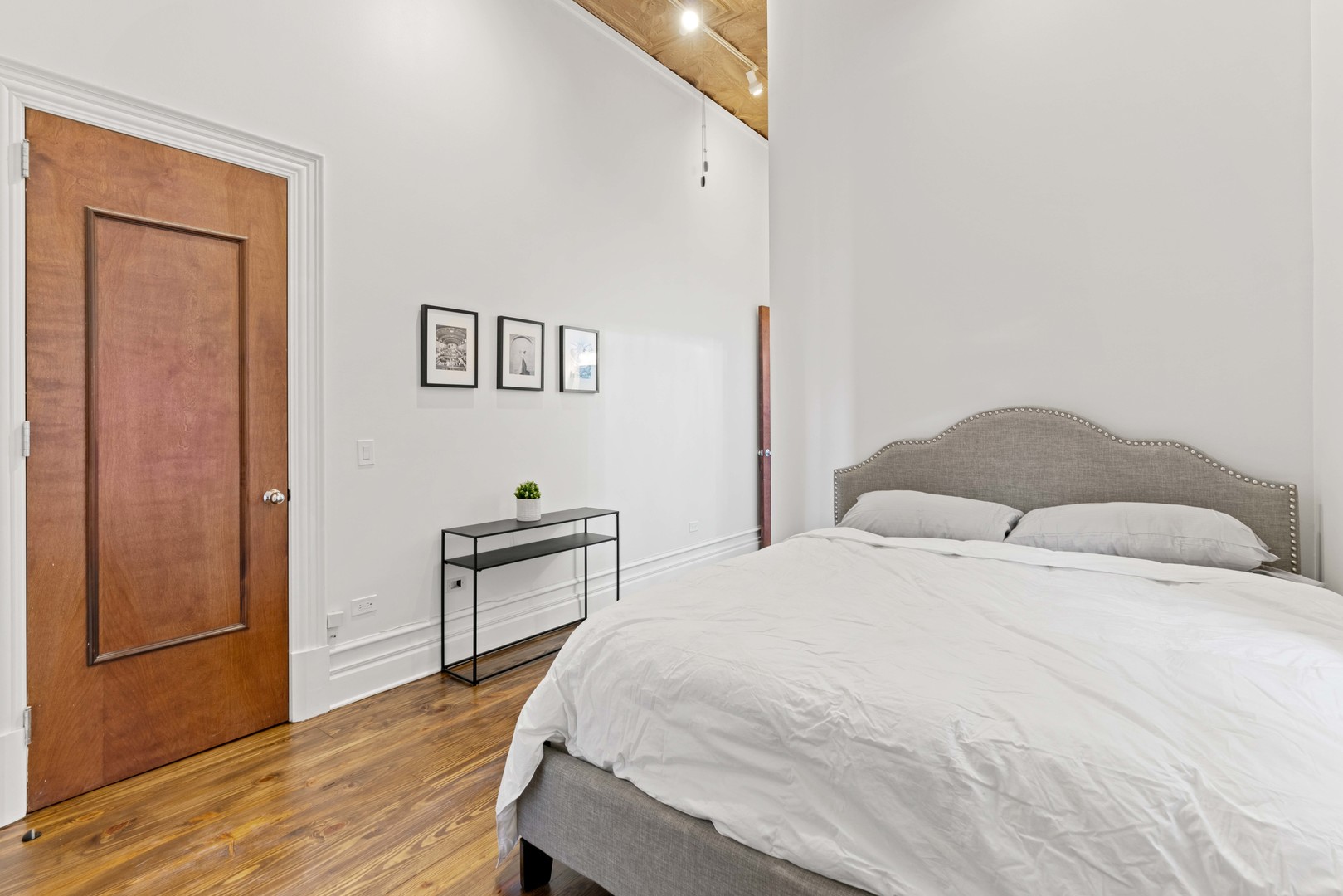 1400 West Chestnut Street, Unit 1 Chicago, IL 60642 - Photo 16 of 24 a bedroom with a bed and wooden floor