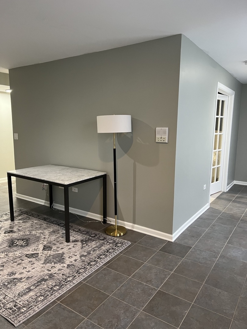 1400 West Chestnut Street, Unit 1 Chicago, IL 60642 - Photo 20 of 24 a view of a room with a table and a potted plant