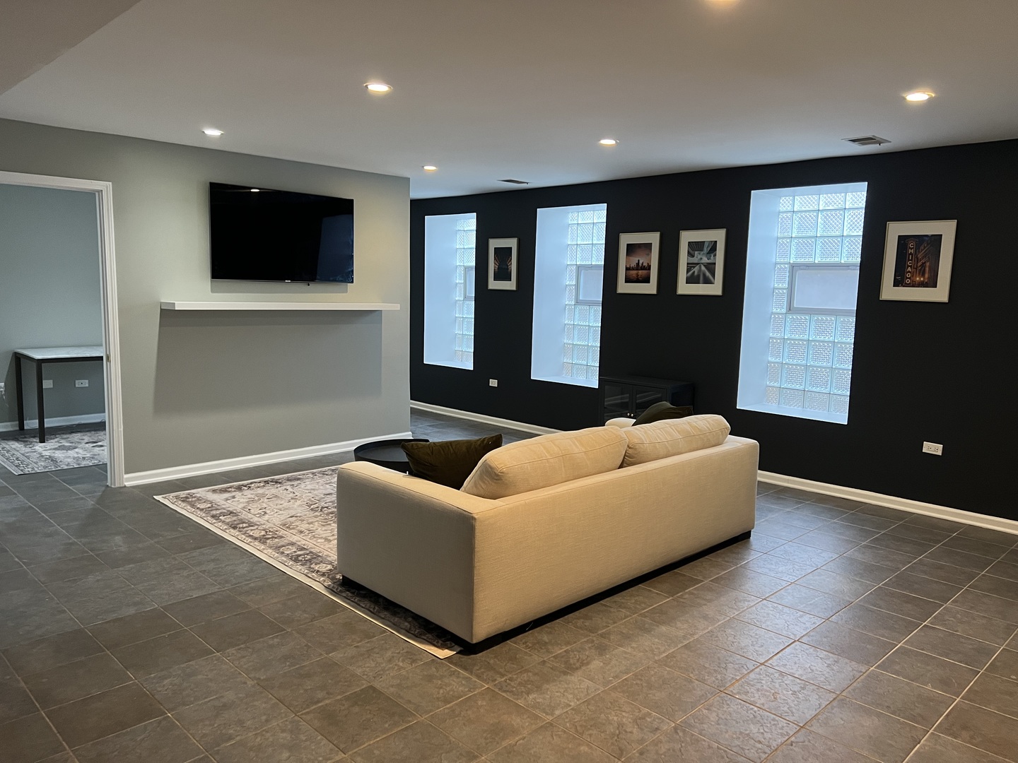 1400 West Chestnut Street, Unit 1 Chicago, IL 60642 - Photo 22 of 24 a living room with furniture and a flat screen tv