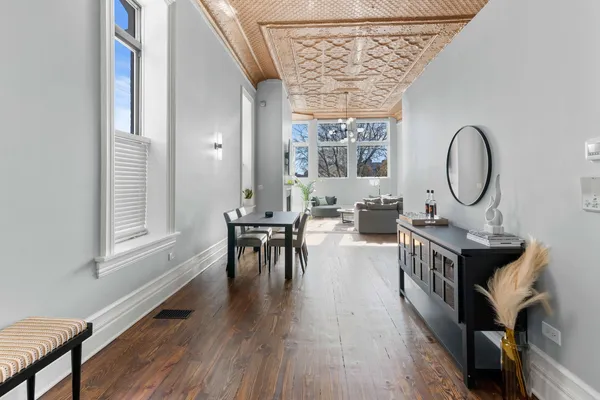 a view of a dining room with furniture and wooden floor