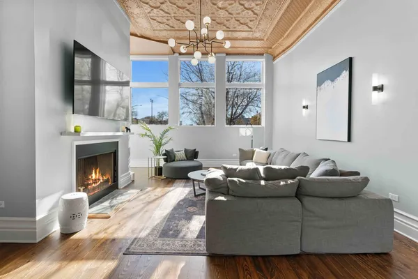 a living room with furniture and a chandelier