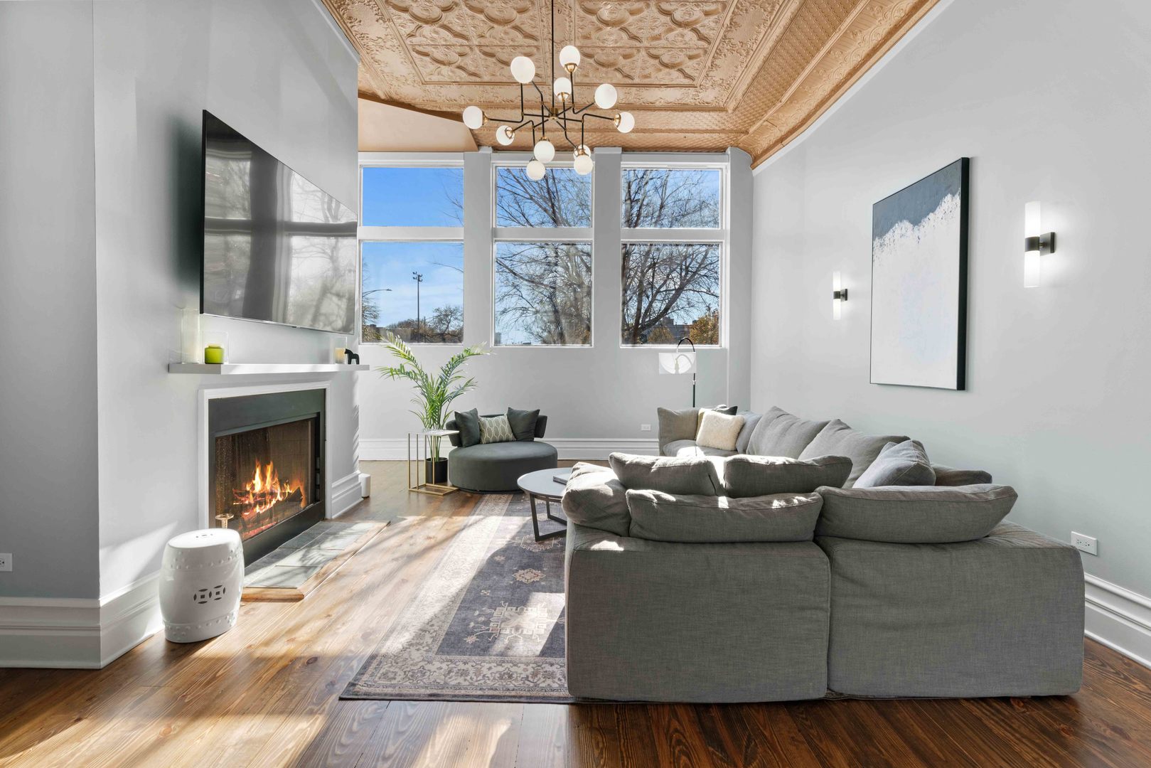 1400 West Chestnut Street, Unit 1 Chicago, IL 60642 - Photo 8 of 24 a living room with furniture a fireplace and a chandelier