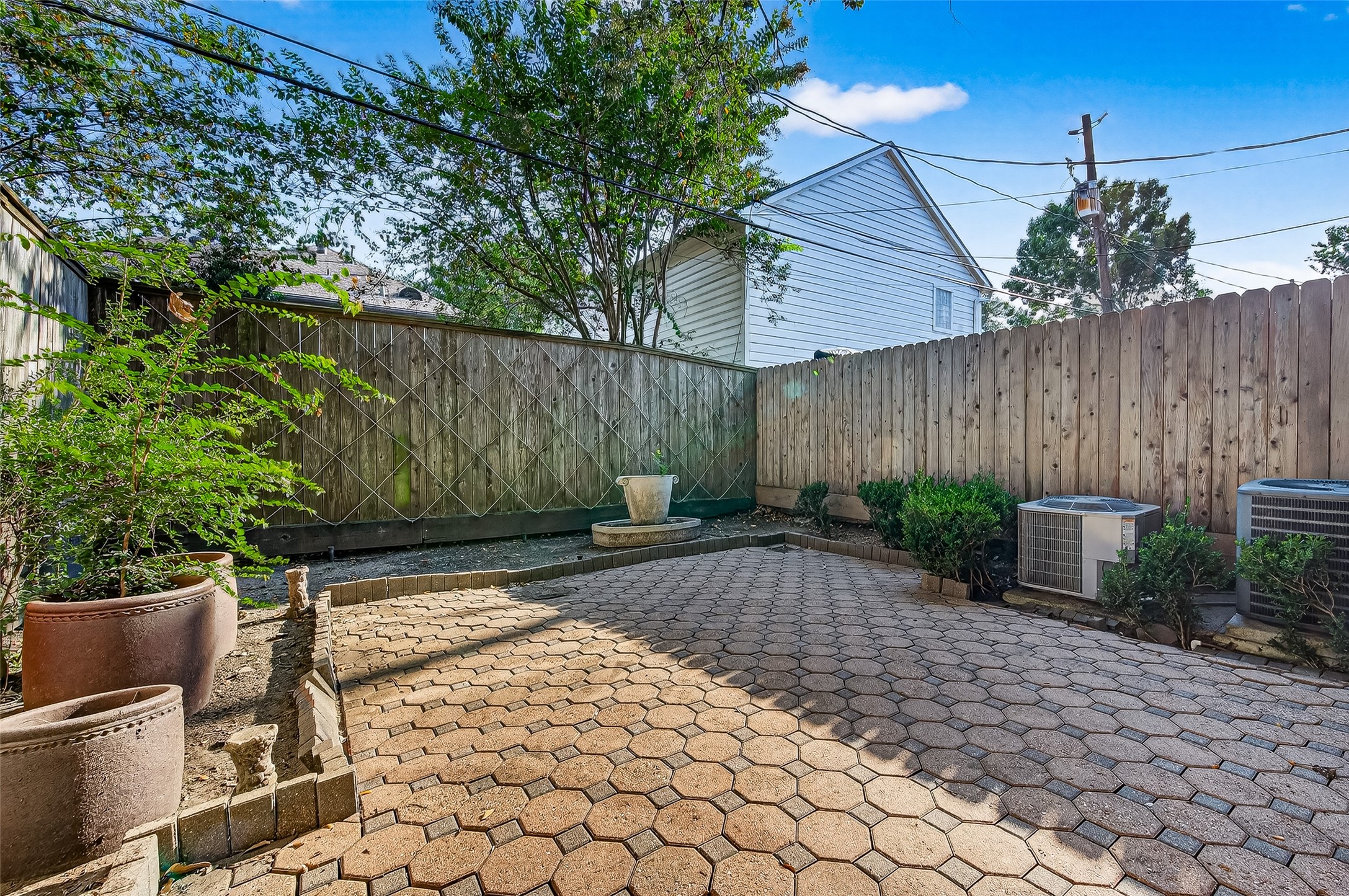 3027 Bissonnet Street Houston, TX 77005 - Photo 44 of 47 A private paved patio with mature trees and greenery — your own outdoor space to enjoy year round