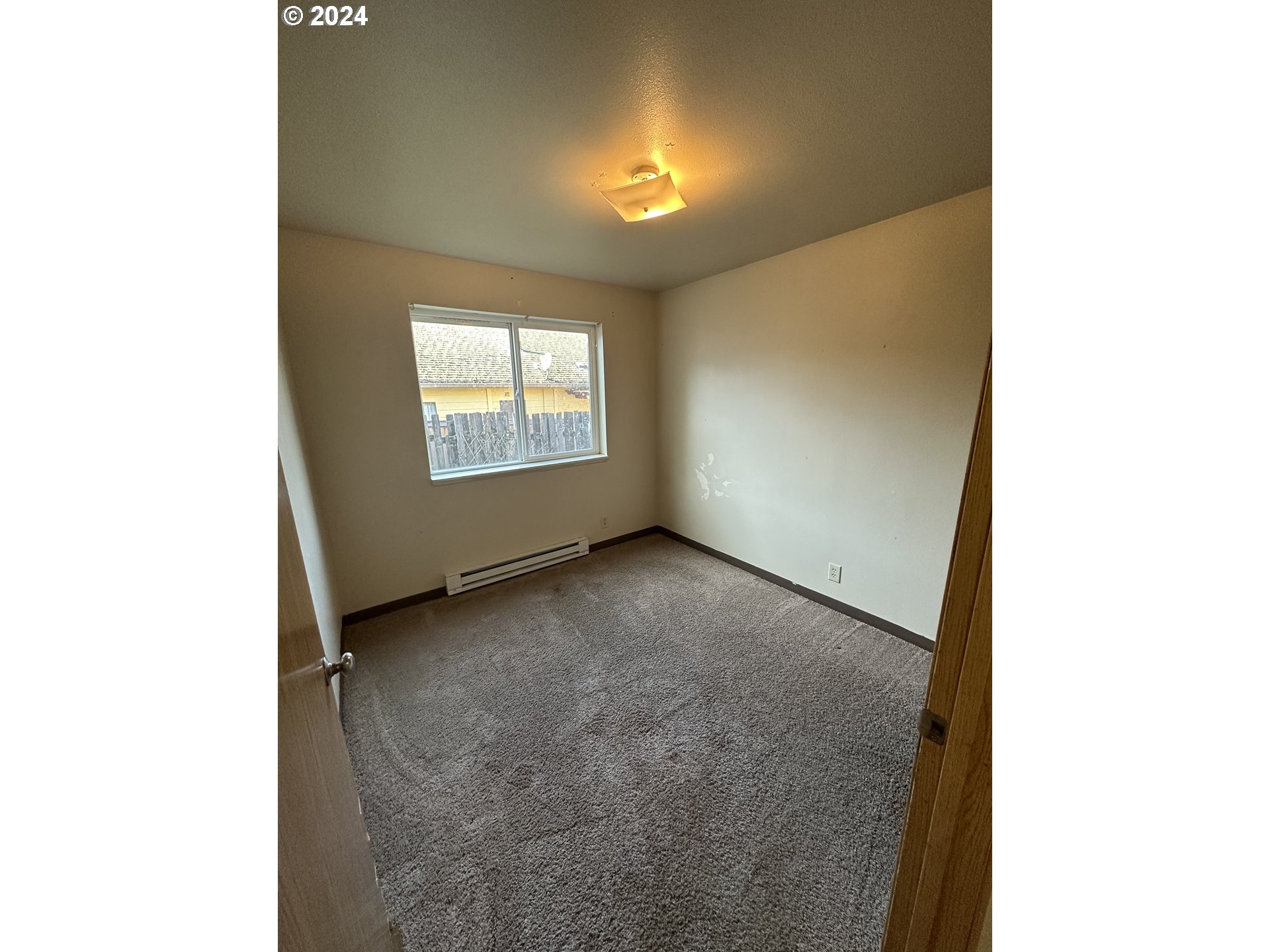 906-908 Pioneer Street Ridgefield, WA 98642 - Photo 12 of 19 a view of an empty room with a window