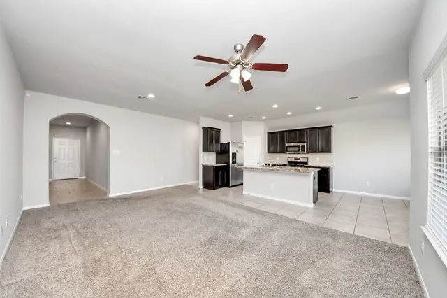 a view of kitchen with refrigerator and window