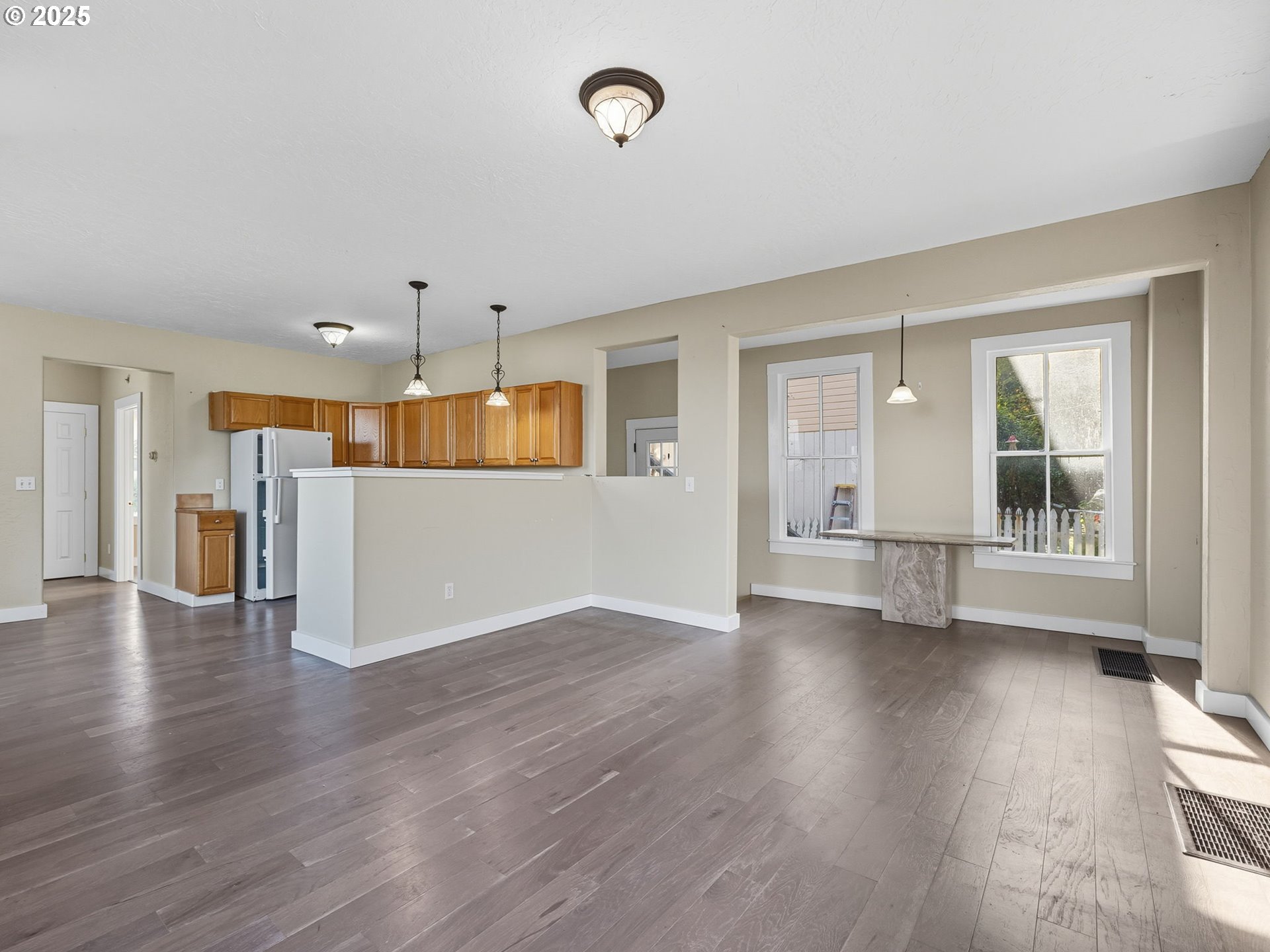 686 29th Street Astoria, OR 97103 - Photo 21 of 48 an empty room with wooden floor and windows