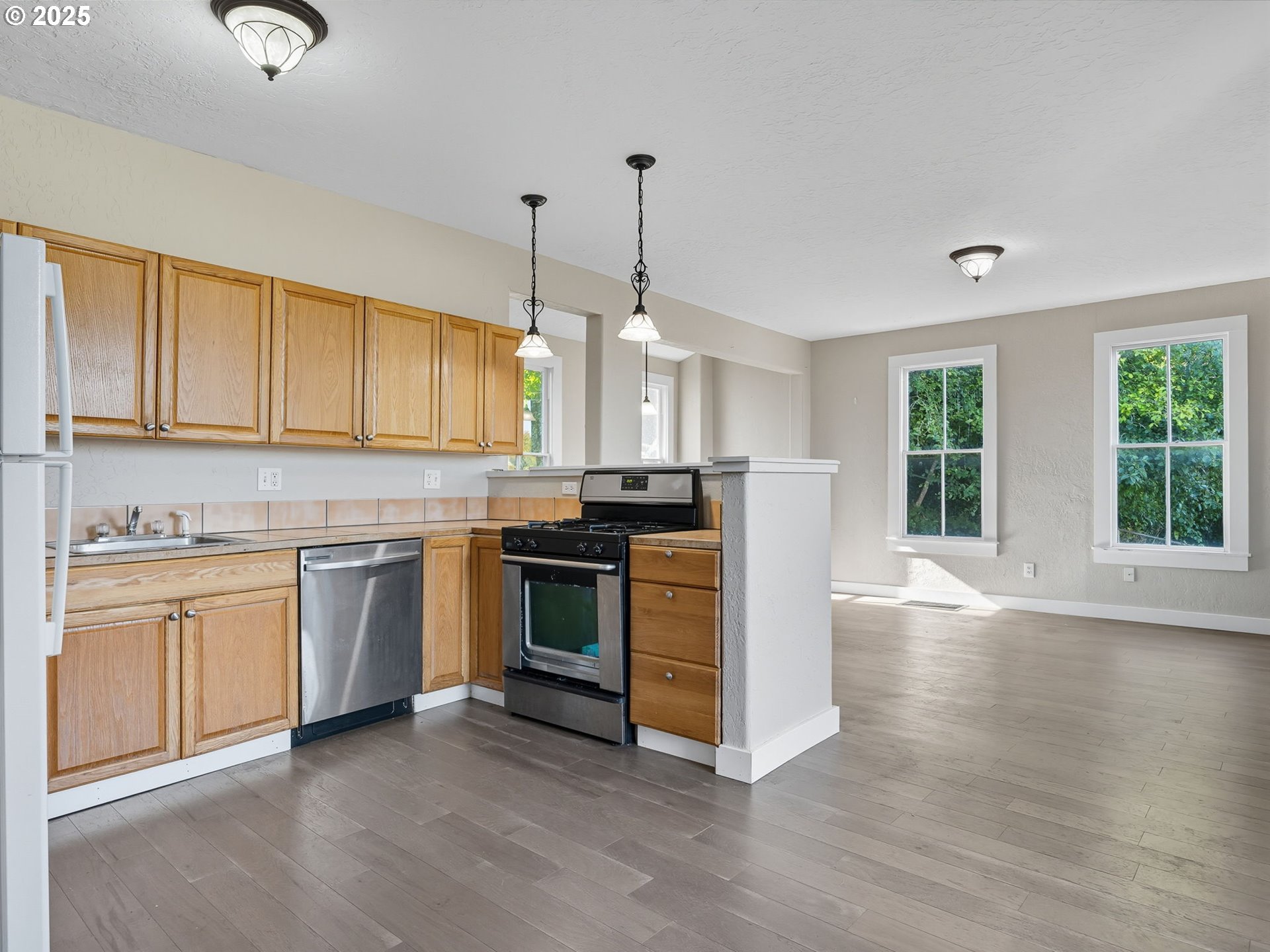 686 29th Street Astoria, OR 97103 - Photo 23 of 48 a kitchen with granite countertop white cabinets and stainless steel appliances