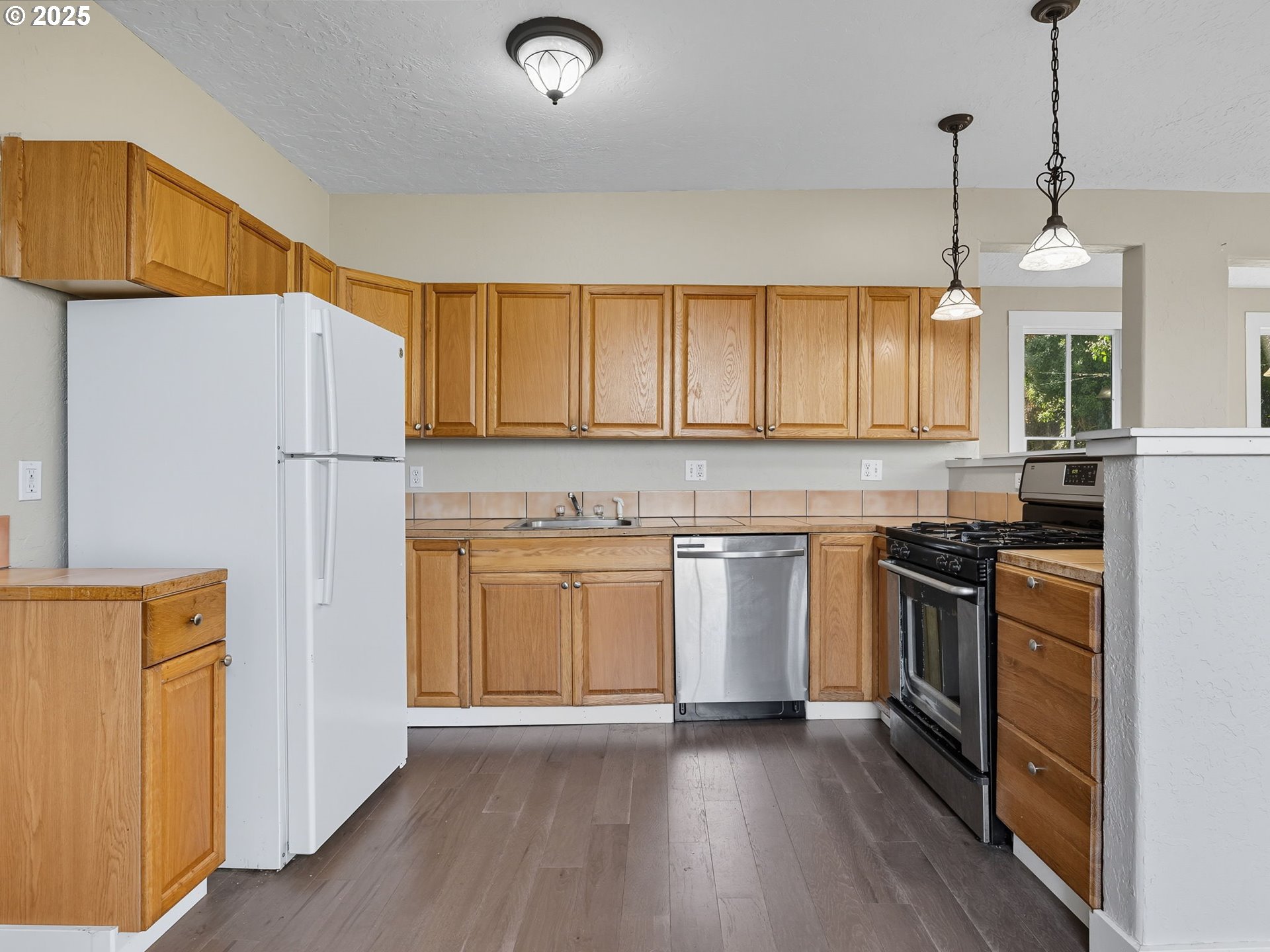 686 29th Street Astoria, OR 97103 - Photo 25 of 48 a kitchen with granite countertop a refrigerator stove top oven and sink
