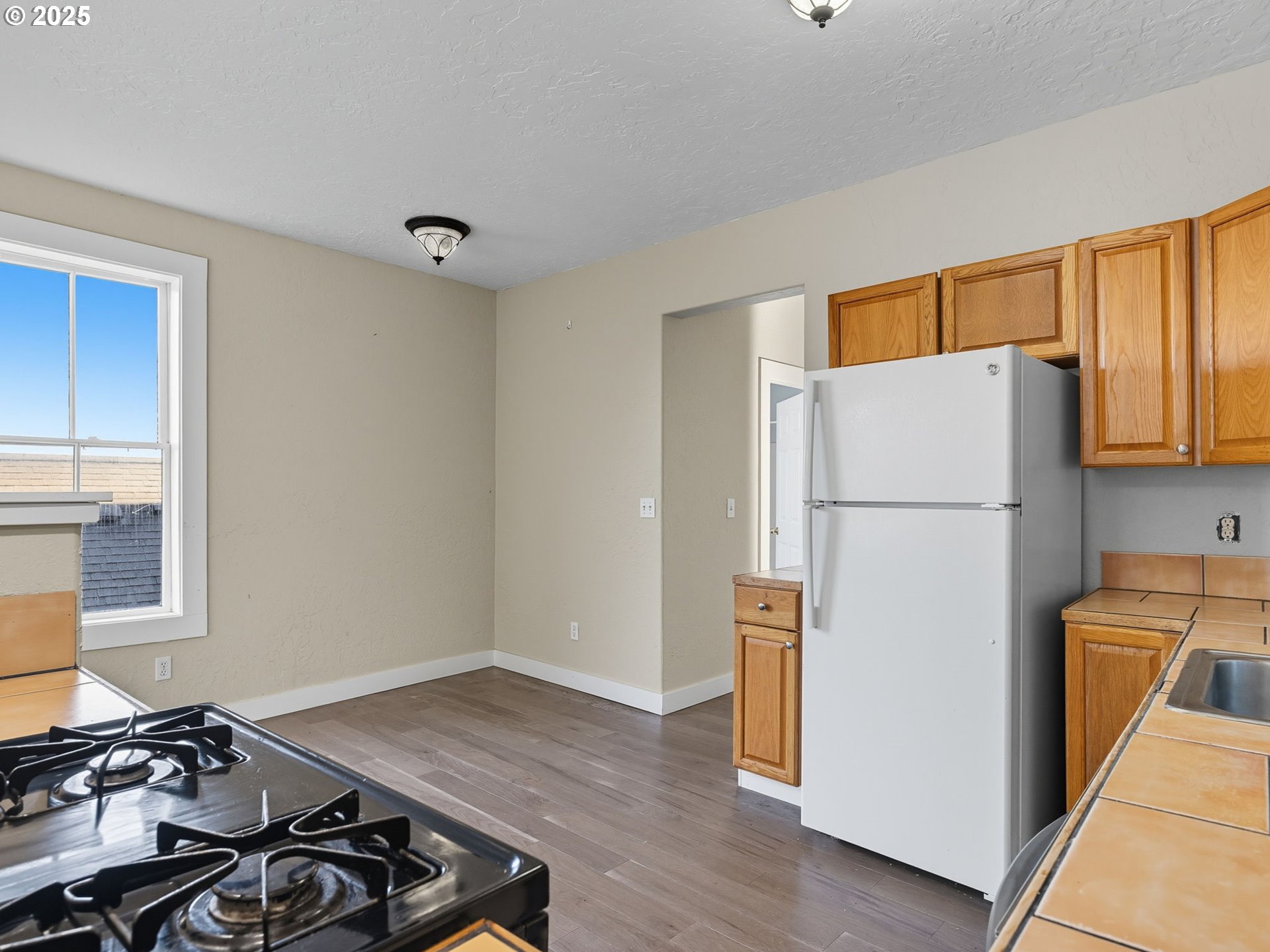 686 29th Street Astoria, OR 97103 - Photo 26 of 48 a kitchen with a refrigerator and a stove top oven
